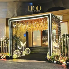 For a modern cocktail or sangeet night, I love creating high-energy, glamorous spaces. This entrance features a dramatic LED light frame, a ceiling of shimmering gold, and whimsical butterfly sculptures to set a vibrant and celebratory tone from the very first step.