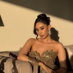Capturing the magic of golden hour for a cocktail glam look. This full-shot highlights how the makeup, with its warm tones and radiant finish, works with the lighting and the metallic sheen of the gown. It's a sophisticated, editorial style perfect for an elegant evening event.