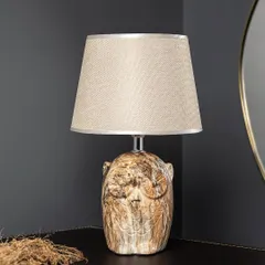 This Owl Wisdom lamp adds a touch of whimsy and character to a room. The ceramic base has a rustic, stone-like texture, and the neutral-colored shade makes it easy to place in any study or living room.