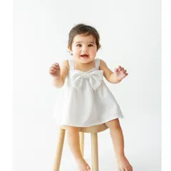 Meet sweet Saira. Her joyful smile lights up the studio in this classic sitter portrait. Using a simple wooden stool keeps the focus entirely on her happy expression and delightful personality.