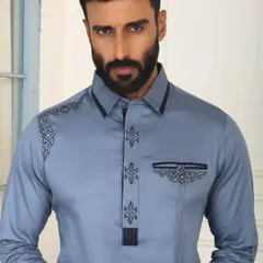 A close-up of the final product, born from a sketch. The precision in this embroidery on this sky-blue Pathani suit is a direct result of a meticulous design process.