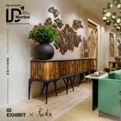 A promotional image for our exhibit at India Design ID, featuring a stunning sideboard from our Koko collection. The piece showcases our love for raw, organic materials, with a body made of reclaimed wood logs set against a sleek, modern frame.