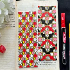 Two more custom bookmarks, each with a unique geometric design. I love playing with different color combinations, like the red, pink, and yellow on the left, and the bold red, black, and gold on the right.