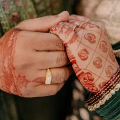 A close-up shot of the newly engaged couple's hands, showcasing their rings and the bride's beautiful mehndi. This intimate shot is all about the details.