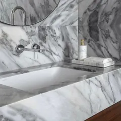 The beauty of natural stone is on full display in this bathroom at the Parishram residence. We used a single type of marble for the countertop and backsplash to create a seamless, monolithic look.