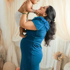 A mother-to-be shares a playful moment with her first child. Capturing the existing family bond before a new baby arrives is a beautiful way to document this special time of transition.