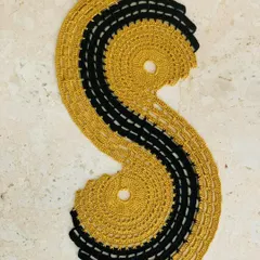 The spiral table runner in a classic and elegant gold and black combination. It's a statement piece that adds a touch of luxury to your table setting.