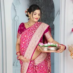 A beautiful portrait of a mom-to-be in a pink bandhani-style saree. The intricate patterns and traditional props create a timeless and authentic image.