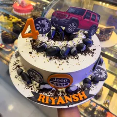 This Jeep-themed cake is perfect for an off-road adventure lover. It features a red Jeep topper, edible rocks, and tire details, celebrating a 4th birthday with a rugged and fun design.