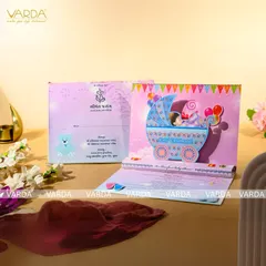 A delightful pop-up card for a baby shower, featuring a colorful 3D baby pram. The inside includes space for event details and a section for the 'Simant Prasang' ceremony, blending modern fun with cultural tradition.