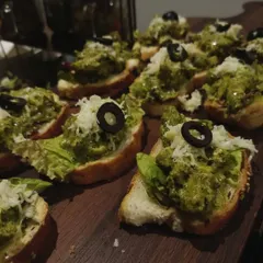 To add a global touch to your menu, I offer appetizers like this Pesto Chicken Bruschetta. It features toasted bread topped with savory pesto, tender chicken, and fresh cheese, making for a perfect bite-sized snack for any occasion.