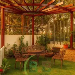 A perfect corner for quiet afternoons. We designed this tranquil garden space in Bannerghatta with a lush lawn, classic wrought-iron seating, and a custom-built wooden pergola that provides dappled sunlight, creating an idyllic and timeless retreat.