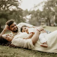 In the middle of the everyday chaos, there are moments of perfect calm. I look for these quiet instances of connection, like this family relaxing together on the grass, their little one nestled safely between them.