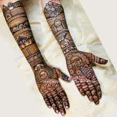 This design is a celebration of traditional Indian motifs. It includes a wedding palanquin (doli), elephants, swans, and peacocks, all woven together in a rich tapestry of henna.