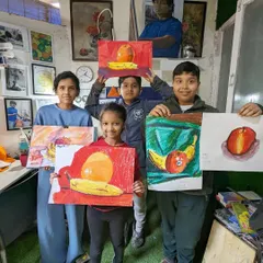 A group of our younger students showing off their still life paintings of fruit. We teach them how to see and draw simple forms, understand color relationships, and compose a balanced image.