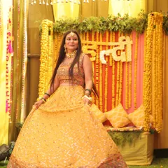 This is a traditional Haldi setup we created, featuring a backdrop of marigold strings and a custom floral sign. The decor is designed to complement the joyful rituals of the ceremony, providing a beautiful setting for the bride.