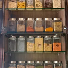 Imagine a pantry where every dal, grain, and snack is visible and fresh. We use decanting and clear labeling to create a system that prevents duplicate purchases and makes finding ingredients a breeze.