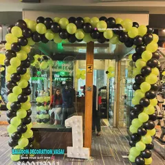 This is a full entrance balloon arch I designed for a gym's first anniversary. The energetic lime green and black color scheme matches the brand, and the large light-up number '1' makes the milestone clear from a distance.