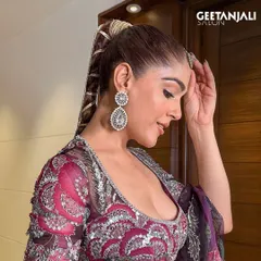 A side profile of our modern bridal hairstyle. The intricate, wrapped ponytail is a unique and stylish choice for a bride who wants to make a statement, while the makeup remains soft and glowing.