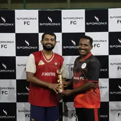 A moment of sportsmanship as the runners-up trophy is awarded. We believe in celebrating participation and effort in all our tournaments.