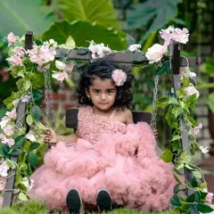 A little princess on her floral throne. Our decorated swing is a favorite spot for magical and dreamy portraits in the garden.