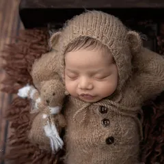 So tiny, so sleepy, and so very loved. This little one, dressed as a cuddly bear, is peacefully dreaming with his tiny teddy friend.