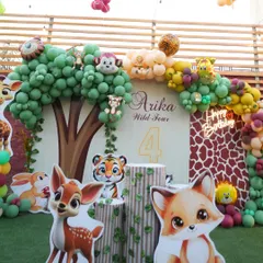 A closer look at the details of our woodland safari theme. We use high-quality cutouts of adorable animals like foxes, deer, and tigers, along with tree-stump pedestals and a giraffe-print backdrop to create a rich, layered look.