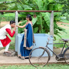We love incorporating unique, rustic elements into our pre-wedding shoots. This charming setup with a vintage bicycle and village well adds a touch of old-world romance to the couple's story.
