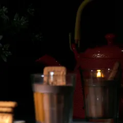 A moody shot of the 'Chai Biscuit' candle, evoking a sense of warmth and nostalgia.
