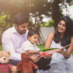 Story time in the park. An outdoor family session is the perfect opportunity to capture your family's favorite activities and genuine interactions.