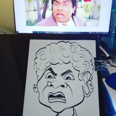 My drawing board setup, showing the hand-drawn caricature of Johny Lever next to the reference photo on my monitor.