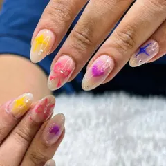 Playing with textures and colors. This "jelly" nail look features translucent colors with cute bow and star designs embedded within the nail for a fun, layered effect.