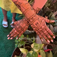 A beautiful baby shower mehendi with personalized details. The design includes baby footprints, the due date "FEB 2025," and other cute motifs.