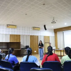 An instructor presents to the cohort, using a projector to share key information. Our workshops combine presentations with interactive activities to cover complex topics like financial literacy and career mapping in an accessible way.