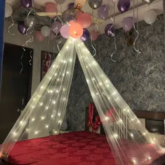 A simple and dreamy birthday bedroom decor. I used a fairy light canopy to create a focal point over the bed, with pink, purple, and silver balloons floating on the ceiling for a soft, celebratory feel.