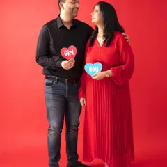 Our solid color backdrops are great for making a statement. This couple used a vibrant red background for their playful gender reveal photo, creating a fun and eye-catching image.