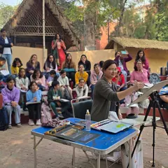 An instructor gives a live watercolor demonstration to an attentive audience during our outdoor session. These events are a great opportunity for hands-on learning in a new environment.