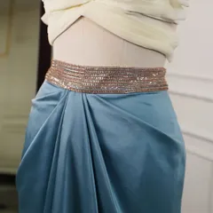 The focus here is on the shimmering, hand-beaded belt and the soft gathers of the draped satin skirt, showcasing my attention to detail.
