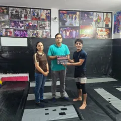 The hard work pays off. One of our team members receiving his certificate and medal after a successful grappling competition.