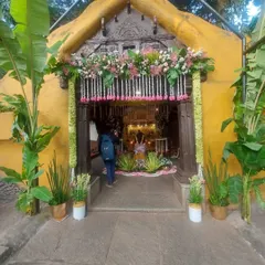 A closer view of the temple-style entrance, where every detail, from the floral arrangements to the potted plants, is layered to feel rooted, fragrant, and full of blessings.