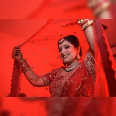 This artistic bridal portrait uses dramatic red lighting to create a striking and memorable image. I focus on capturing the bride's personality, here using the veil to frame her happy expression on her wedding day.