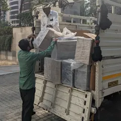 The project begins with the delivery of materials. Here, our team carefully unloads the new FRP planters from the truck.