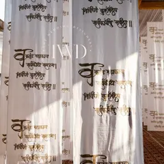 For a spiritual gathering, we created an immersive space with hanging fabric scrolls printed with sacred Sanskrit chants. The light filtering through them created a serene and divine ambiance.