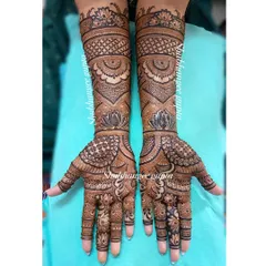 This is a classic example of a full coverage engagement mehndi design. The pattern uses a mix of geometric checks, delicate lotus flowers, and traditional motifs for a rich and balanced look.