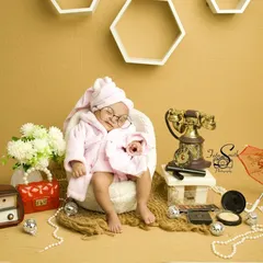 A different take on the 'Luxury Baby' theme. This sleeping newborn looks so peaceful and pampered, surrounded by vintage props and makeup accessories. It's a fun, creative, and completely unique newborn portrait.