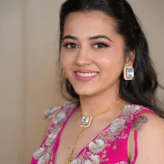 A soft, romantic look perfect for a wedding guest or bridesmaid. The makeup features pretty pink tones on the eyes and lips, paired with a simple half-up hairstyle.