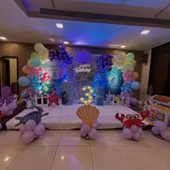 Dive into an underwater adventure! This enchanting Mermaid theme was for a 3rd birthday in Chembur. I used a shimmering sequin backdrop, character cutouts of Ariel and her friends, a light-up number '3', and balloon sculptures of crabs and octopuses to bring the ocean magic to life.
