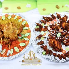 A colourful display of our non-veg platters, featuring chicken biryani and a variety of fried chicken and quail starters, garnished with fresh onions and cucumbers.