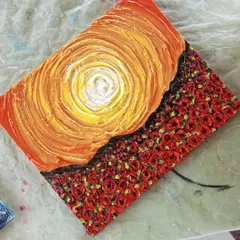 A different style of texture art, this piece combines a swirling, textured sunset with a field of tiny, sculpted roses. This shows how you can use texture paste to create both broad strokes and fine details.