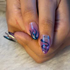 Not basic, just iconic. This close-up shows our skill with chrome art, featuring a metallic blue flame and a snake design on a sheer, purple-tinted base.